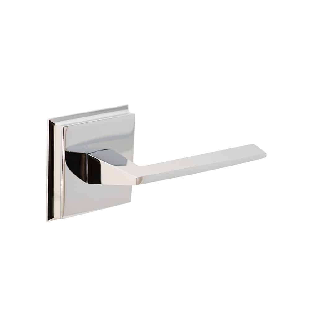 A modern door handle attached to a square base with a polished chrome finish