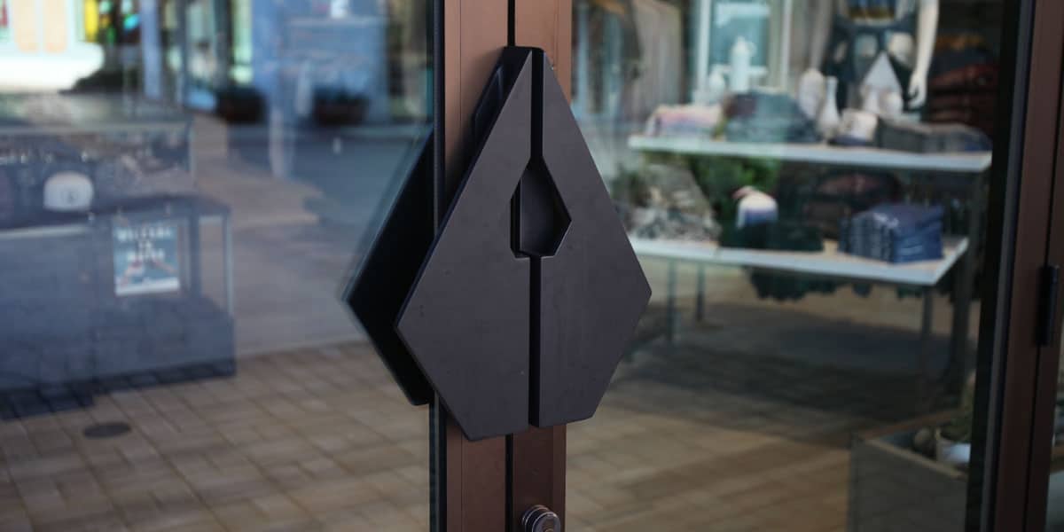 Unique black geometric door pull on a glass door