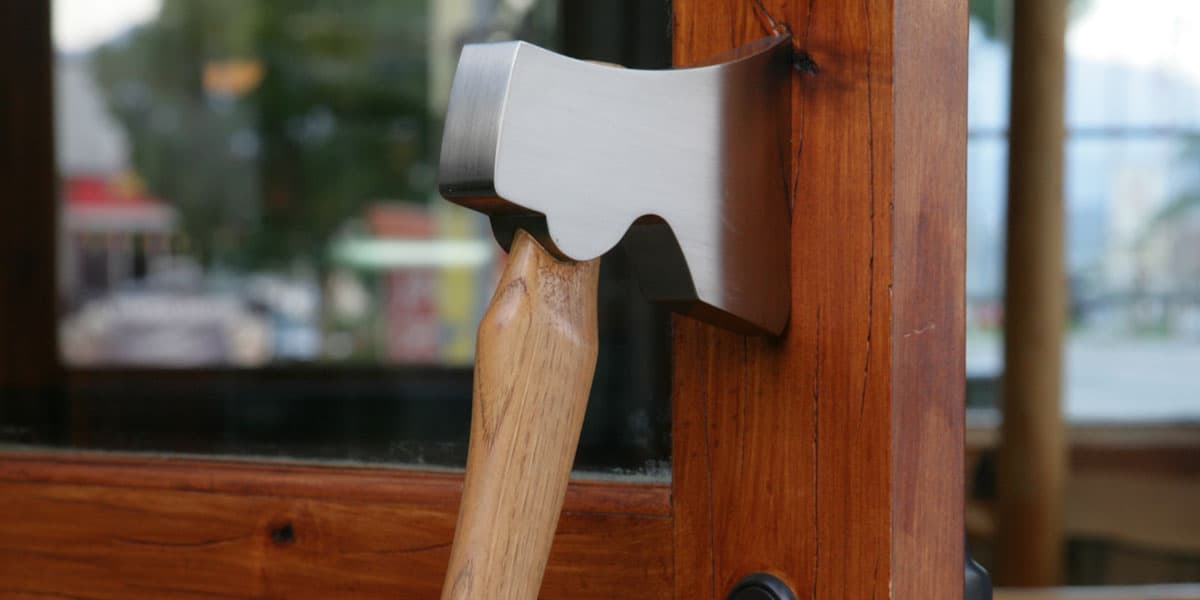 Custommade axe handle door pull embedded in wooden door frame