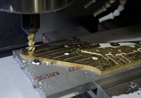 CNC machine drilling into a metal plate