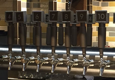Seven custom made beer tap handles.